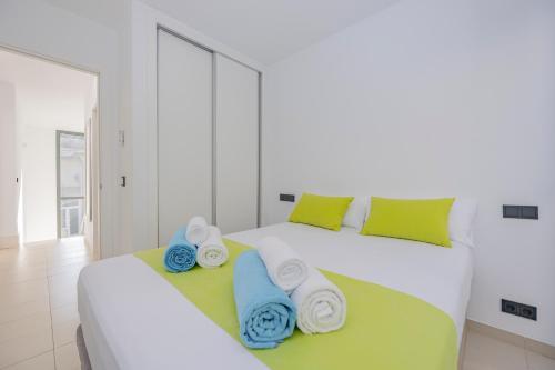 two beds with towels on them in a bedroom at Villa PAM, ALYA Beach House with pool and Hot Tub in Alcudia