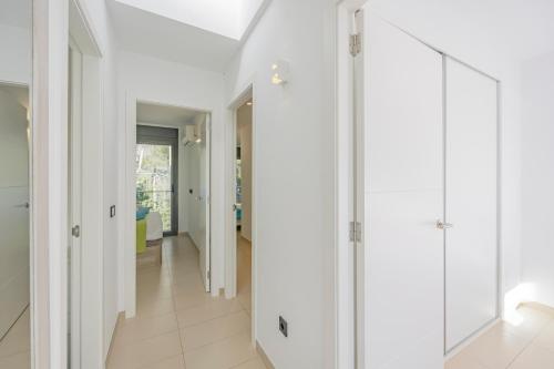 a hallway of a house with white cabinets at Villa PAM, ALYA Beach House with pool and Hot Tub in Alcudia