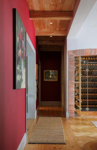 a hallway with a red wall and a wine cellar at Constantia Klein in Cape Town