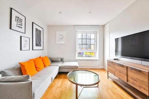 a living room with a couch and a flat screen tv at Canary Wharf Views in London