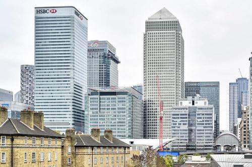 a group of tall buildings in a city at Canary Wharf Views in London