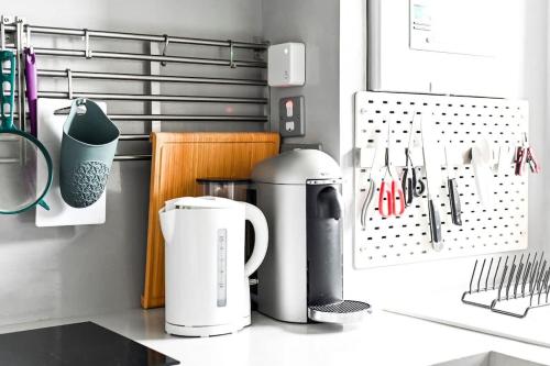 a kitchen counter with two white appliances on a counter top at Canary Wharf Views in London