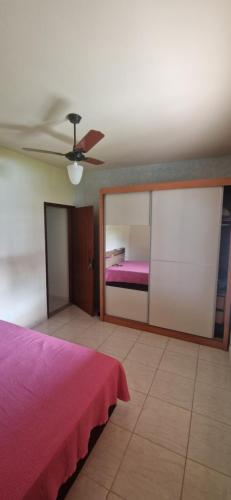 a bedroom with a bed and a ceiling fan at Holidays in Itaipuaçu Beach in Maricá