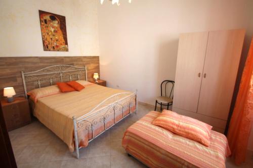 a bedroom with two beds and a cabinet at Perla in Marina di Mancaversa
