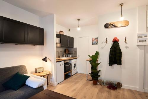 un salon avec un canapé et une cuisine dans l'établissement Appartement lumineux hyper centre, à Clermont-Ferrand