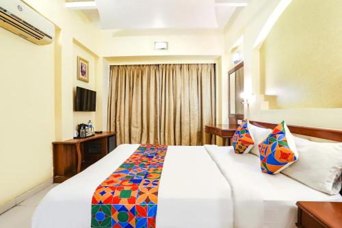 a hotel room with a bed and a window at FabHotel Shubhangan - Nr Bandra in Mumbai