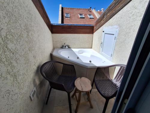 a small bathroom with two chairs and a sink at Mina Boutique in Jerusalem