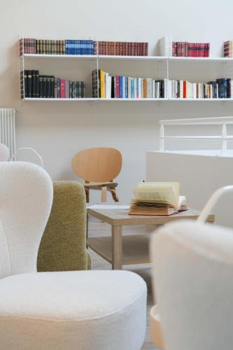 a room with chairs and a table and books at Logis Thermal in Saubusse