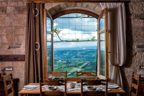 a dining room with a table and a large window at Panoramic View Villa in OliveGroves in Heraklio