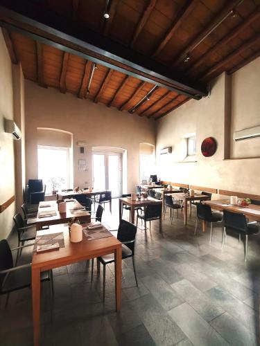 a dining room with wooden tables and chairs at San Rocco Hotel in Scanzorosciate