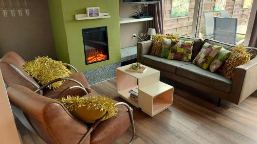 a living room with a couch and a fireplace at Vakantiehuis Jade in Bruinisse