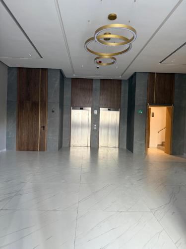 a large empty room with a ceiling with a chandelier at Sky View Malabata Family only in Tangier