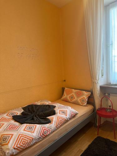 a bedroom with a bed with a robe on it at Ferienhaus Löwenherz in Pommern
