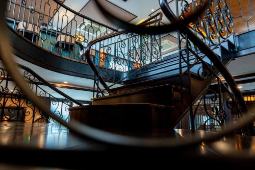 a spiral staircase in a building with a railing at Indochine Grand Lan Ha Bay in Ha Long