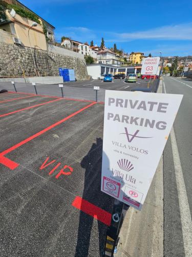 a sign in the middle of a parking lot at Villa Volos , free private parking in Opatija