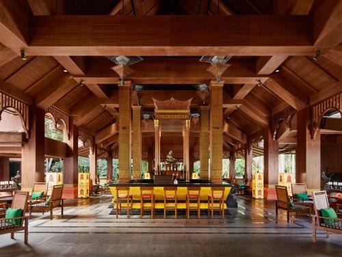 a large room with a yellow table and chairs at InterContinental Xishuangbanna Resort by IHG in Jinghong