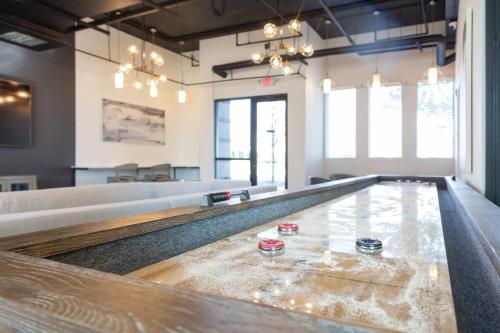 a large room with a table with glasses on it at Modern Uptown 2BR Free Parking & Private Balcony in Charlotte