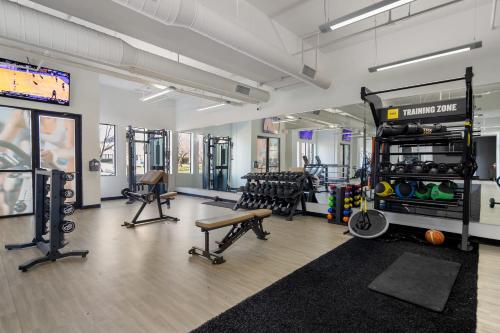 a gym with a lot of equipment in a room at Modern Uptown 2BR Free Parking & Private Balcony in Charlotte