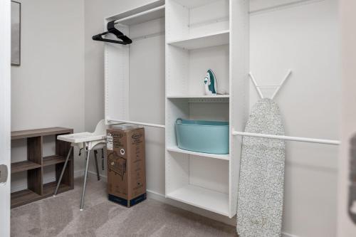 a room with a white refrigerator and a desk at Modern Uptown 2BR Free Parking & Private Balcony in Charlotte