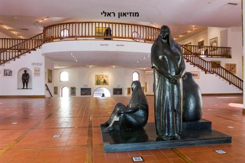 a statue of two women sitting on the floor of a museum at Caesarea Vacation Rooms in Caesarea