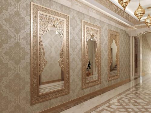 a row of mirrors on a wall in a room at Volidam Hotel in Samarkand