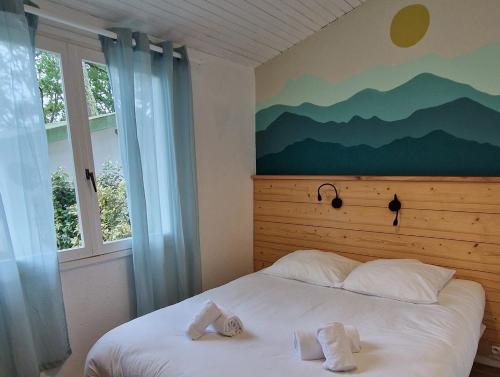 a bedroom with a bed with two towels on it at Cap Océan in Seignosse