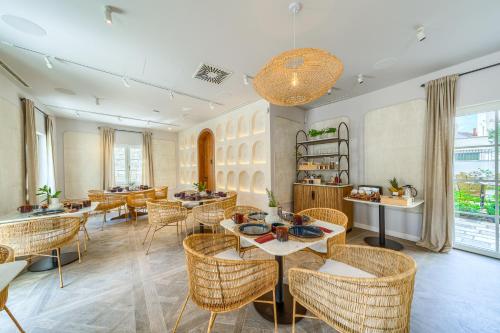 a restaurant with tables and chairs and a large window at Hotel Brattia, Adults Only, Heated Pool, A la Carte Breakfast, Postira, Brač Island in Postira