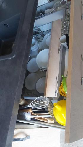 a drawer filled with white dishes and utensils at La Crozat in Giez