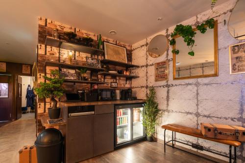 a kitchen with a counter and some plants on the wall at Suite Prohibition - Love & atypique room sauna & spa in Issoudun