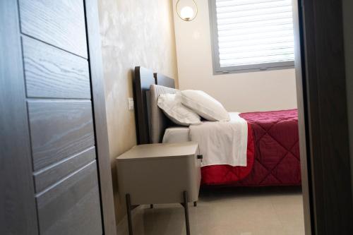a small room with a bed and a chair at Pietra Viva Suite e Relax in Veglie