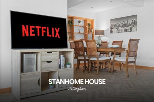 a living room with a television and a dining room table at Vibrant 2-bed Home in Nottingham by Renzo, Free Driveway Parking, Sleeps 6! in Nottingham