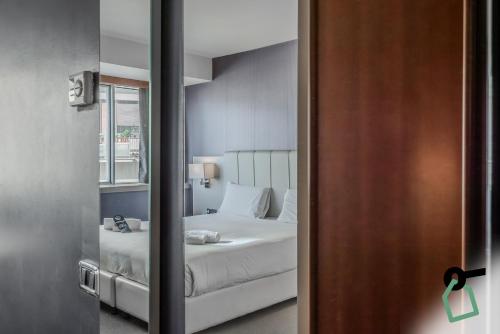 a bedroom with a white bed and a window at HOTIDAY Room Collection - Trapani in Trapani