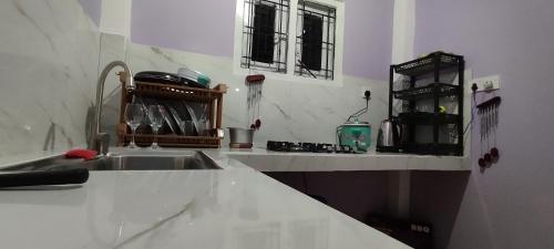 a kitchen with a sink and a counter top at Rolling Waves Midigama East in Midigama