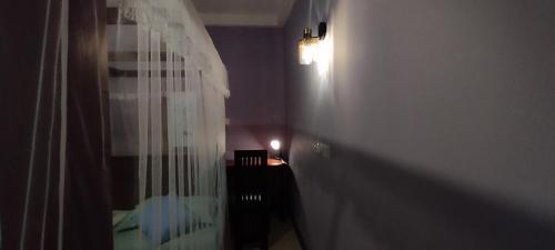 a bathroom with a shower curtain in a room at Rolling Waves Midigama East in Midigama