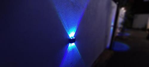 a blue light on the side of a wall at Rolling Waves Midigama East in Midigama