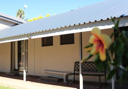 a white pavilion with a bench and a flower at Luxury Heights Bed and Breakfast in Newcastle