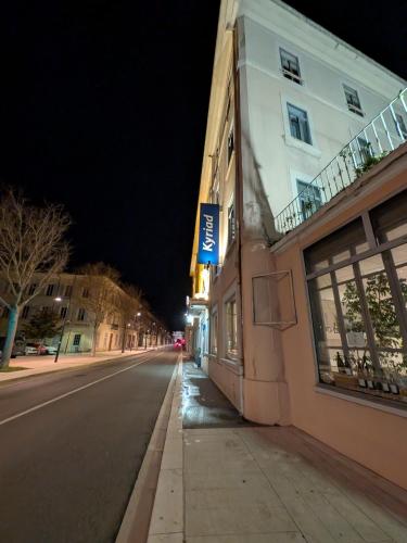 an empty city street at night with a building at KYRIAD ORANGE Centre Ville - HOTEL & RESTAURANT & BAR - La Galerie d'Art des Princes - Provence Alpes Côte d'Azur - France - Proche A7-A9 - exit21- Châteauneuf-du-Pape Avignon Bollene Nimes - 24h-24h in Orange