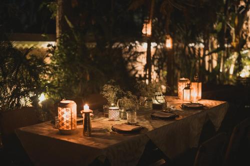 a long table with candles and lights on it at Brij Paraiso Saligao, Goa - An Indo-Portuguese Villa in Calangute