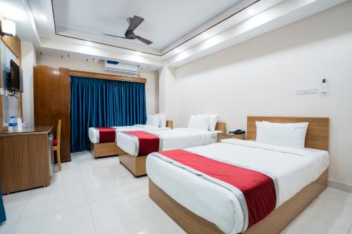 a hotel room with two beds and a television at Hotel Safa Residency - DHAKA in Dhaka