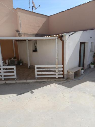 a porch of a building with a bench next to it at Casa Vacanza da Sara in Custonaci