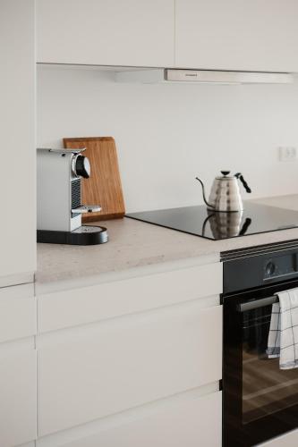 a kitchen with a stove and a microwave at Clover House by Daniel&Jacob's in Copenhagen