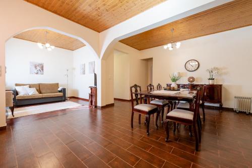 a living room with a table and chairs and a couch at Domingos House - Valley View in Boaventura