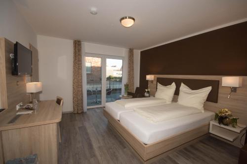 Postel nebo postele na pokoji v ubytování Hotel Sonne am Meer