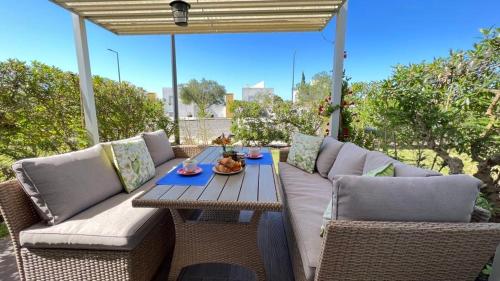 a patio with a couch and a table and chairs at Casa Roxana in Porches