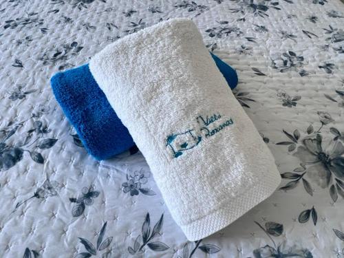 a white and blue towel on a bed at Casa Roxana in Porches