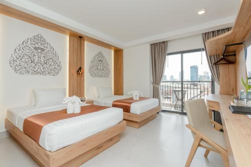 Postel nebo postele na pokoji v ubytování Botum Domrey Hotel