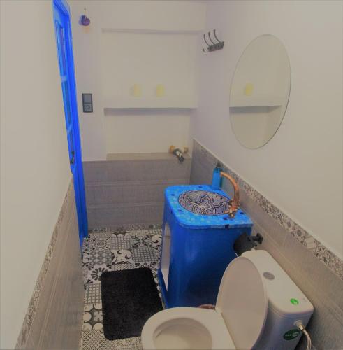 a small bathroom with a toilet and a sink at CASA TROUSSI in Chefchaouene