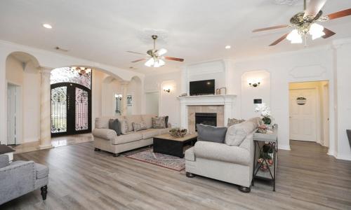 a living room with two couches and a fireplace at La Casa De Francella in Houston