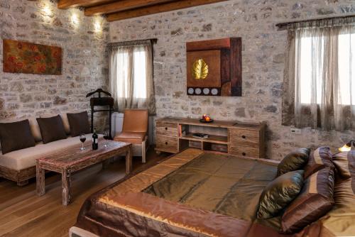 a living room with a couch and a table at Elafos Spa Hotel in Elliniko