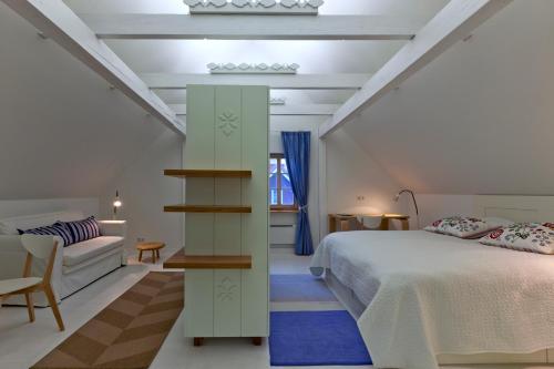 a bedroom with a bed and a book shelf at Vila Balta Balta in Nida